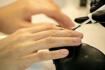 Professional nail polish application in a beauty salon.