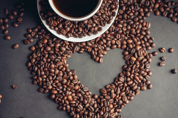 heart drawn from coffee beans and a cup with a drink saucer breakfast in bed