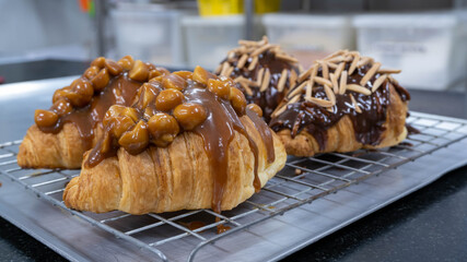 croissant with caramel sauce macadamia nut almond stick  dark chocolate on top
