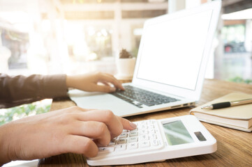 Man using, working on laptop with blank screen in meeting room.