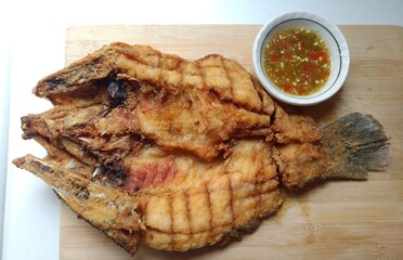 Deep-fried sea bass cooked until crispy and golden-brown, delicious to eat.