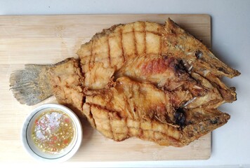 Deep-fried sea bass cooked until crispy and golden-brown, delicious to eat.