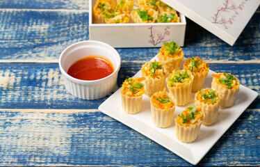 Malaysian Peranakan Chinese thin and crispy pastry tart shell appetizer dish or locally known as "Pai Tee" with dipping sauce. Selective focus.