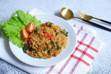 a plate of fried rice served with vegetables 