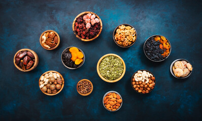 Fototapeta na wymiar Nuts and dried fruits. Dried apricots, figs, prunes, raisins, cranberries, pecans, walnuts, pistachios, cashews, hazelnuts, almonds and other. Food background, top view