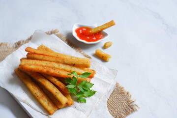 potato cheese stick served with sambal in white background