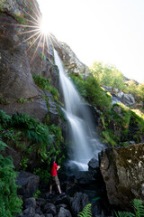Obraz premium Unrecognizable person under the waterfall, long exposure