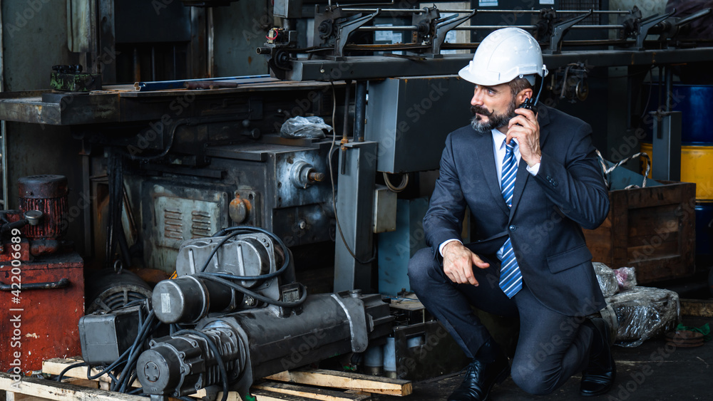 Wall mural engineering engine machine controller manager control concept, technical engineer checking, working and talking on radio communication to tell worker working in industry