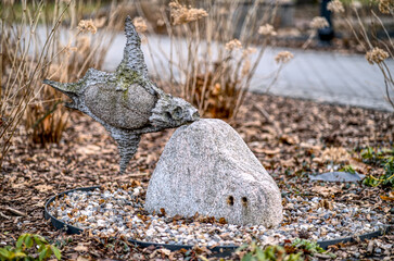 Unusual sculpture of fish standing by the street in Cracow