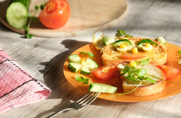 Plate with creative and simple breakfast  for children. Funny food art for kids. Sandwich with vegetables for child, Morning light and shadow. Shallow DOF