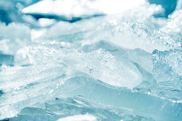 Fototapeta na wymiar Stacks of drift ice piled up against the dutch coast with crystal clear sunlight