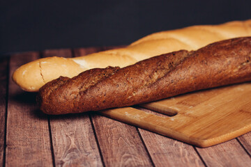 fresh crispy loaf cutting board knife wooden table flour product