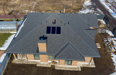 Aerial top view of new modern residential house cottage water heat system on roof. Renewable...