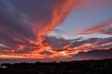 red sunset over the ocean and mountains