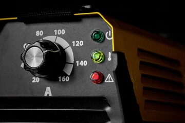 Inverter welding machine. Equipment for welding metals on a wooden desktop.