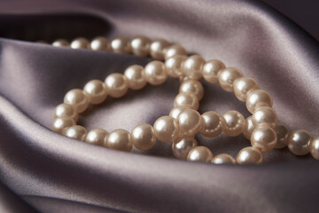 Pearl necklace on black background, close-up