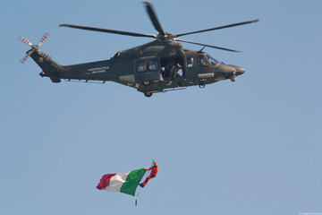Fototapeta premium Helicopter flying with Italian flag at an airshow