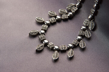 Elegant necklace with diamonds on grey background with copy space