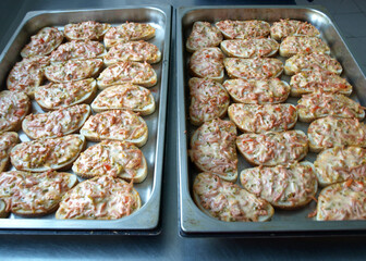 metal pan and toasted bread slices with cheese, school catering concept, lunch for students