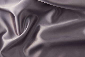 Gray silk fabric background, top view, close-up