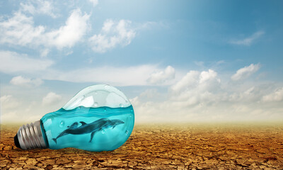 Light bulb with Dolphins swimming inside oncracked earth. Saving environment and natural conservation concept.