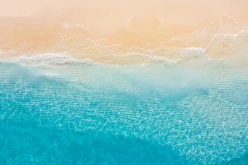 Rolgordijnen Summer seascape beautiful waves, blue sea water in sunny day. Top view from drone. Sea aerial view, amazing tropical nature background. Beautiful bright sea with waves splashing and beach sand concept © icemanphotos