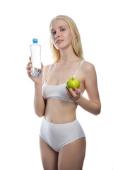 Fitness woman happy smiling holding apple and water bottle. Healthy lifestyle photo of Caucasian fitness model isolated on white background.