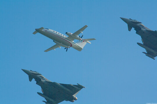Fighter jets formation escorting piaggio p180 avanti