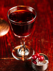 red alcoholic gooseberry cocktail. On a wooden bar