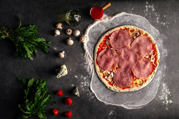Prepared dough base for cooking pizza with ham and cheese