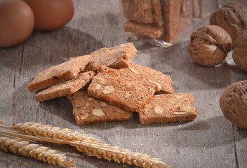 Baked nuts cinnamon cookies on rustic kitchen background.