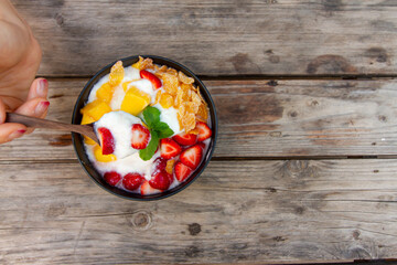 yogurt mixed fruit Strawberries mango conflex mint on wooden table top view