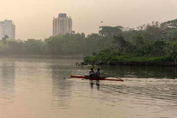 Two rowers resting while rowing in the morning at Rabindra Sarobar lake, Kolkata. Concept of...