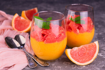 Cream Kurd from grafruit in glasses on a gray background. Close-up.