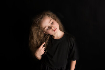 Young positive child in headphones listening music with fun raise hands up. Funny girl wear stylish protective face mask due coronavirus COVID 19 pandemic. Family lifestyle on summer school holidays.