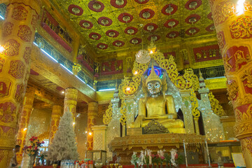 a golden Buddha statue in popular temple at Kyaw Tha, Myanmar