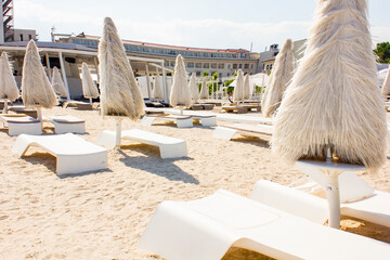 A view of empty beach with beach umbrellas during sunny and windy day