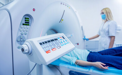 Radiologist with a female patient in the room of computed tomography