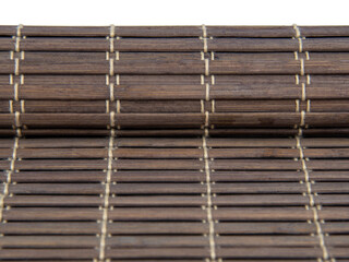 Rolled bamboo mat for food dark color isolated on the white background