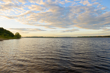 Fototapeta na wymiar Evening summer landscape with the river bank