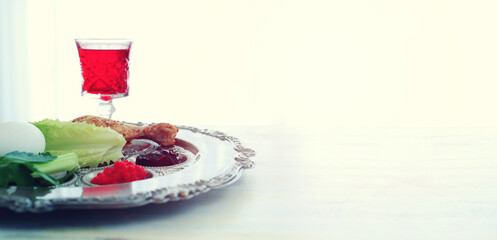 Passover background. Glass Wine cup and traditional plate