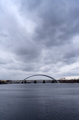 Podilsko-Voskresensky bridge under the dark skies in Kyiv