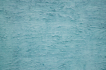 textured plaster made on a blue-colored wall. High quality photo