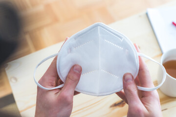 Pulling on ffp2 face mask: Close up of ffp2 mask