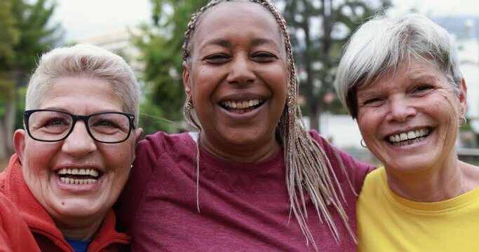 Close up of multiracial senior women smiling in camera
