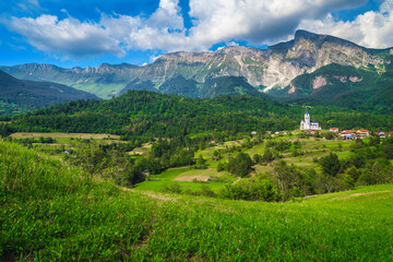 Fototapeta premium Wonderful alpine scenery and Dreznica mountain village with church, Slovenia