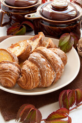 Croissants with jam, sliced on a white plate