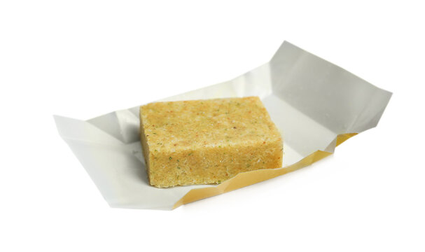 Unwrapped bouillon cube on white background. Broth concentrate