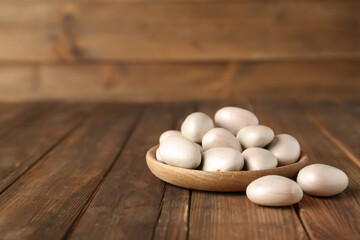 Raw jackfruit seeds on wooden table. Space for text