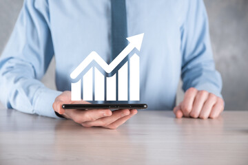 Businessman man holding a graph with positive profits growth. plan graph growth and increase of...